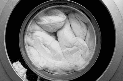White linens in industrial washing machine