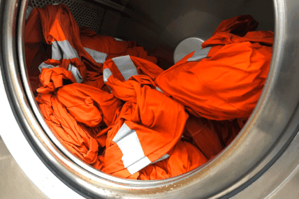 Orange workwear in industrial washing machine